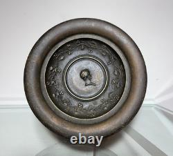 Antique Art Deco bronze bowl adorned with an African marabout holding a snake