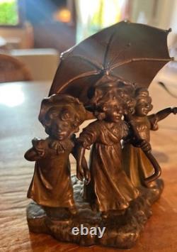 Antique Art Deco bronze statue depicting three little girls under an umbrella