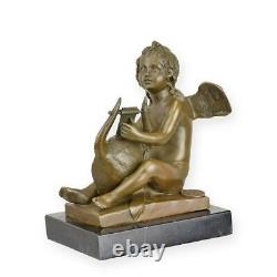 Sculpture of a Putto playing the lyre in bronze Art Deco style signed